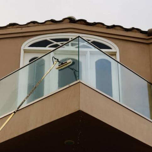 A window cleaning service is being performed on the outside of a building.